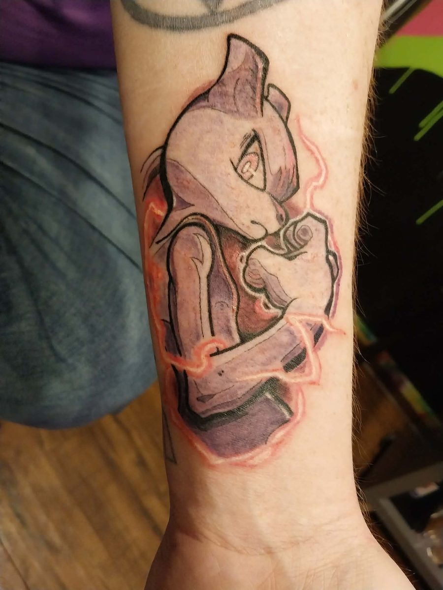 Full-colour character tattoo with a crackling electric aura, on a forearm